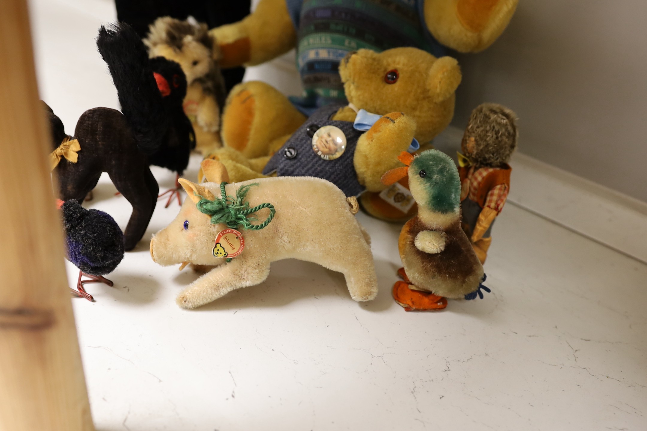 A collection of toys - a small black cat, a large black cat, a small pig, a hedgehog, a Macki hedgehog, two crows, a duck, two small birds with wire feet and two Peter Bull bears with pedigree certs. (12)